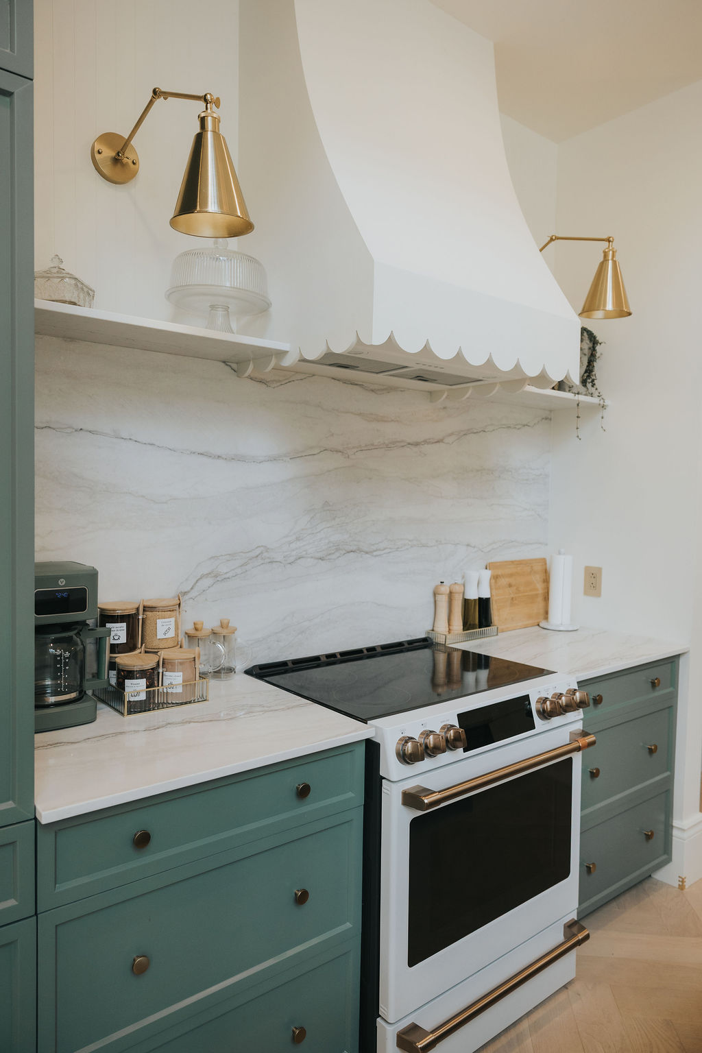 Cuisinière blanche sous une hotte sculpturale