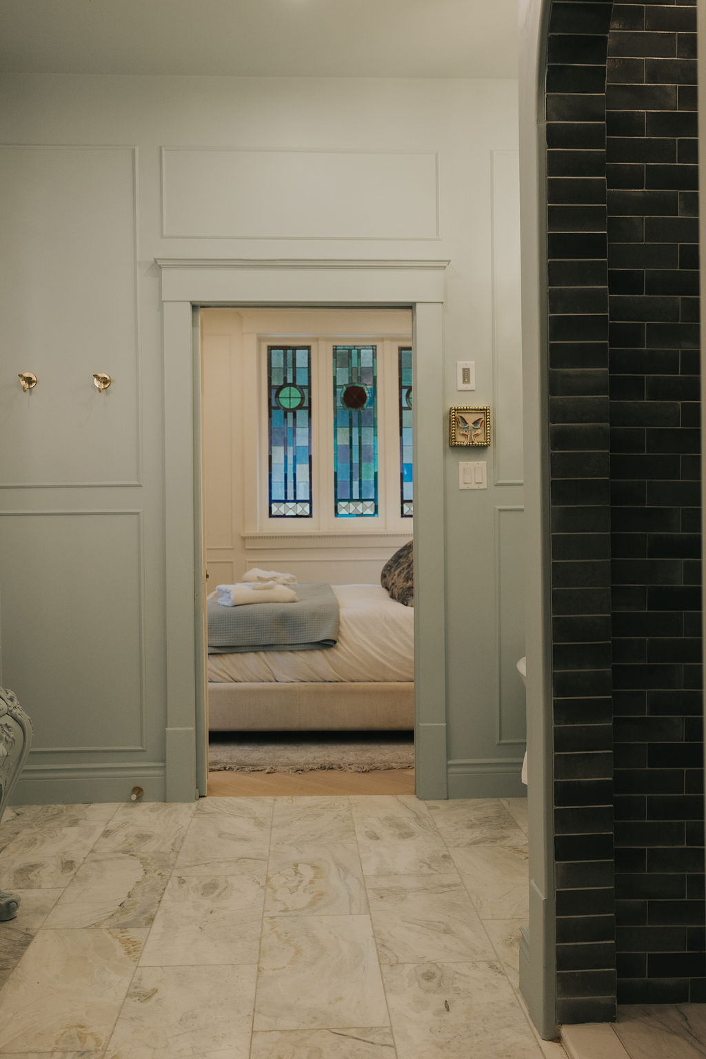 Salle de bain et chambre séparées par des vitraux